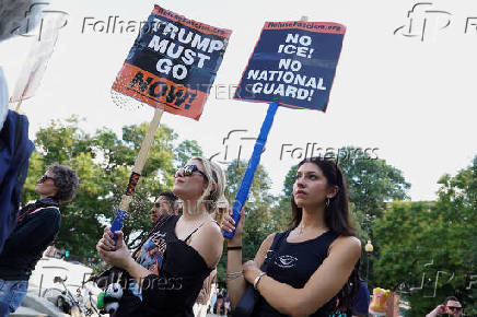 People protest after U.S. President Trump announced he would deploy the National Guard to the nation's capital and place D.C.'s Metropolitan Police Department under federal control, in Washington