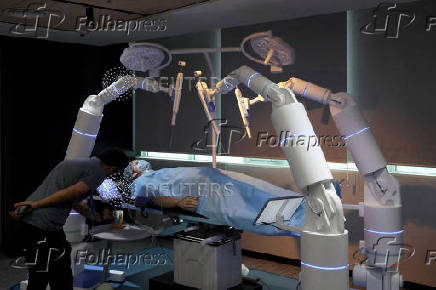 A man inspects a model of a robotic surgical system inside the innovation lab at Wipro's premises in Bengaluru