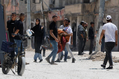 Palestinians carry their belongings after Israel's decision to demolish their homes in Nur Shams camp
