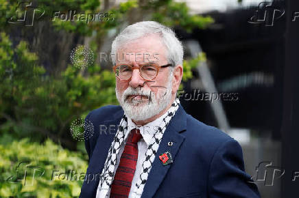Former Sinn Fein President Gerry Adams sits outside the High Court, in Dublin