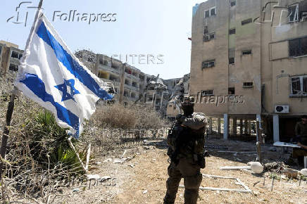 Security personnel works at an impact site following a missile strike from Iran on Israel, in Holon, Israel