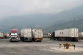 Container trucks cross the Tianbao port in Malipo county