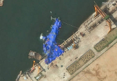 A satellite image shows a North Korean warship covered with a blue tarp after an accident that occurred during its launch at the shipyard in Chongjin