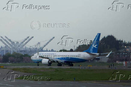 FILE PHOTO: A Boeing 737 MAX plane, intended for China's Xiamen Airlines, arrives at Seattle's King County International Airport after returning from China due to ongoing tariff disputes