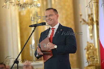 Polish President-elect Karol Nawrocki receives the winning certificate