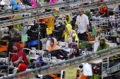 Bangladeshi garment workers sew at a textile factory in Gazipur