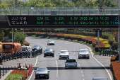 FILE PHOTO: An electronic board shows Shanghai and Shenzhen stock indices, in Shanghai