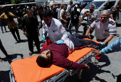 Palestinian casualties are brought into Al-Aqsa Martyrs Hospital, following an Israeli strike, in Deir al-Balah