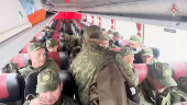 Russian soldiers pose for cameras in Belarus after release from Ukraine on second day of POW exchange