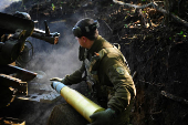 Ukrainian servicemen fire a self-propelled howitzer towards Russian troops at a frontline near the town of Chasiv Yar