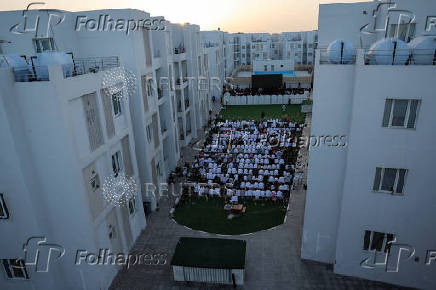 Palestinians from Gaza attend Eid al-Adha prayers, at Al Thumama Complex,  in Doha