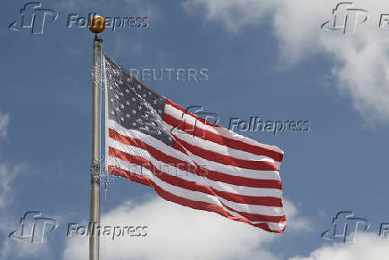 An American flag flies outside the Embassy of the United States in Airai