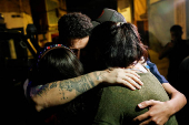 Arturo Suarez, who was held for months in an El Salvador prison, greets family members after his release, in Caracas