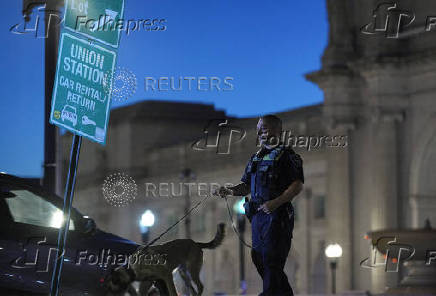 A police officer walks with a dog near the Union Station, in Washington