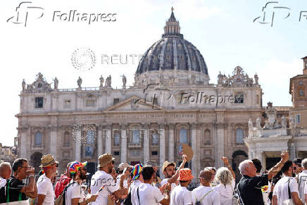 LGBTQ+ pilgrims walk toward St. Peter's Basilica