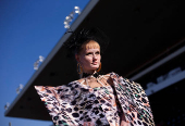 A model prepares to take part in a fashion competition during the Durban July horse race in Durban