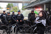 A pro-Palestinian protester demonstrates outside Calgary Municipal Building, on the first day of the G7 Leaders' Summit, in Calgary