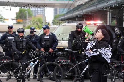 A pro-Palestinian protester demonstrates outside Calgary Municipal Building, on the first day of the G7 Leaders' Summit, in Calgary