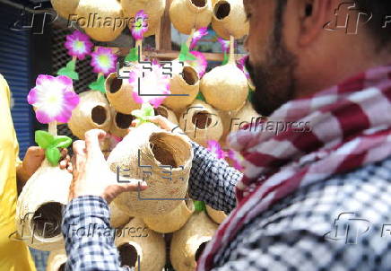 A vendor sells handmade birds nests in Hyderabad
