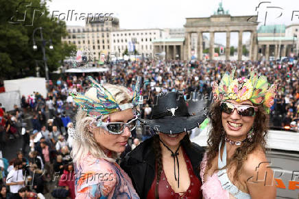 Revellers attend the 'Rave The Planet' techno parade, in Berlin