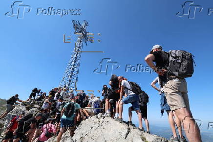 Hikers on the Giewont summit in the Tatra Mountains