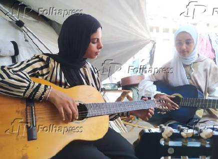 Palestinian children learn music to forget the war and destruction.
