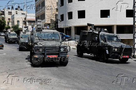 Israeli military vehicles manoeuvre during an Israeli raid in Nablus