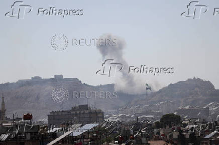 Smoke rises following Israeli airstrike next to the presidential palace in Damascus