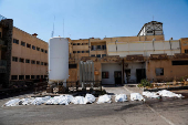 Covered bodies lie on the ground in Sweida