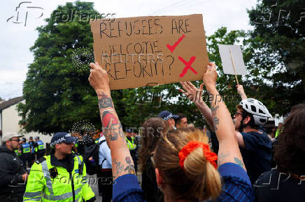 Anti-racism protesters attend a counter protest, on the day of anti-immigration demonstrations outside the Bell Hotel in Epping