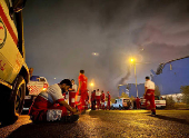 Iranian Red Crescent rescuers work following an explosion at the Shahid Rajaee port in Bandar Abbas