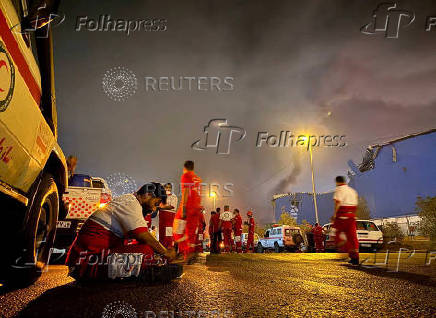 Iranian Red Crescent rescuers work following an explosion at the Shahid Rajaee port in Bandar Abbas