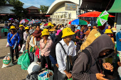 Cambodian people queue to cross the closed Khlong Luek Border Checkpoint