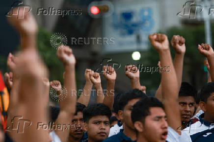 Demonstrators march to demand justice for the disappearance of students of Ayotzinapa Rural Teachers' College, in Mexico City