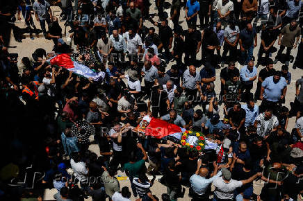 Mourners take part in the funeral of of Sayfollah Kamel Musallet, killed amid the Israel-Gaza conflict, near Ramallah