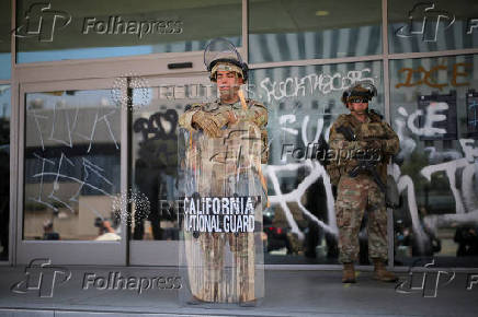 California National Guard troops stand outside the Edward R. Roybal Federal Building, in Los Angeles