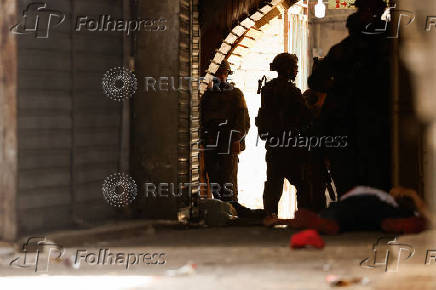 A Palestinian casualty lies on the ground after he was attacked by Israeli forces during a raid in Nablus