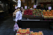 People shop in Jerusalem following an Israeli strike in Iran