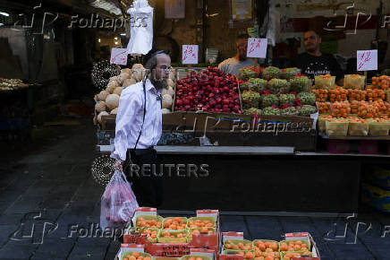 People shop in Jerusalem following an Israeli strike in Iran