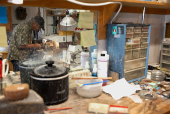 Craftsperson George Graybeal polishes a hat pin at his rock shop in Marfa