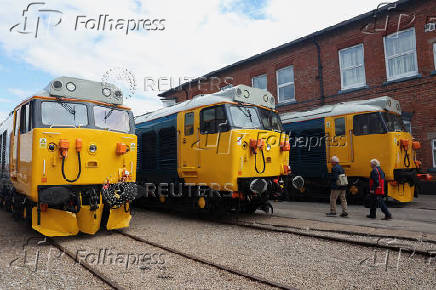 Visitors walk past engines on display at The Greatest Gathering, a railway festival marking 200 years of rail history, at Alstom?s Litchurch Lane factory in Derby