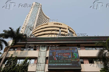 A screen displays an image of U.S. President Donald Trump at the Bombay Stock Exchange (BSE) after Trump's tariff plan announcement, in Mumbai
