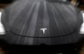 The logo of Tesla is seen on a Tesla car in Brussels