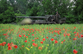 Servicemen of the Ukrainian Armed Forces ride a self-propelled gun toward Russian positions on a front line in Donetsk region
