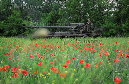 Servicemen of the Ukrainian Armed Forces ride a self-propelled gun toward Russian positions on a front line in Donetsk region