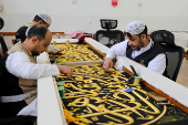Workers prepare the Kiswa, a silk cloth that covers the Kaaba, ahead of the annual hajj pilgrimage