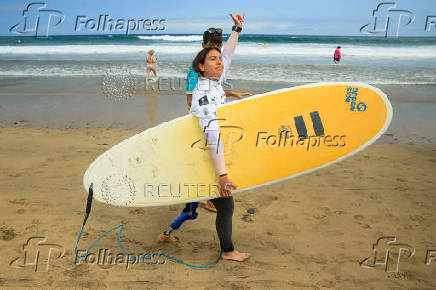 Surfer Mireia Cabanes greets the public before entering the water during the adaptive surfing Open LPA Surf City No Limit in Las Palmas de Gran Canaria