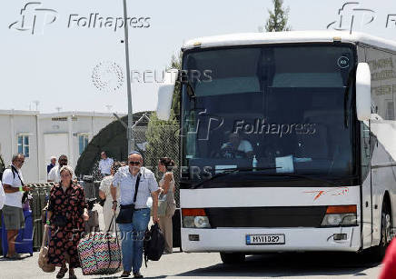 French nationals evacuated from Israel to Cyprus walk outside the Joint Rescue Coordination Center 