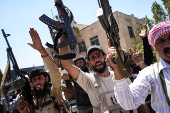 Fighters from Bedouin tribes deploy in the Druze-majority town of Mazra'a