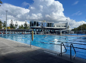 People swim in the Centenary Pool at Spring Hill